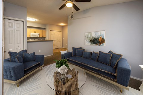 a living room with blue couches and a coffee table